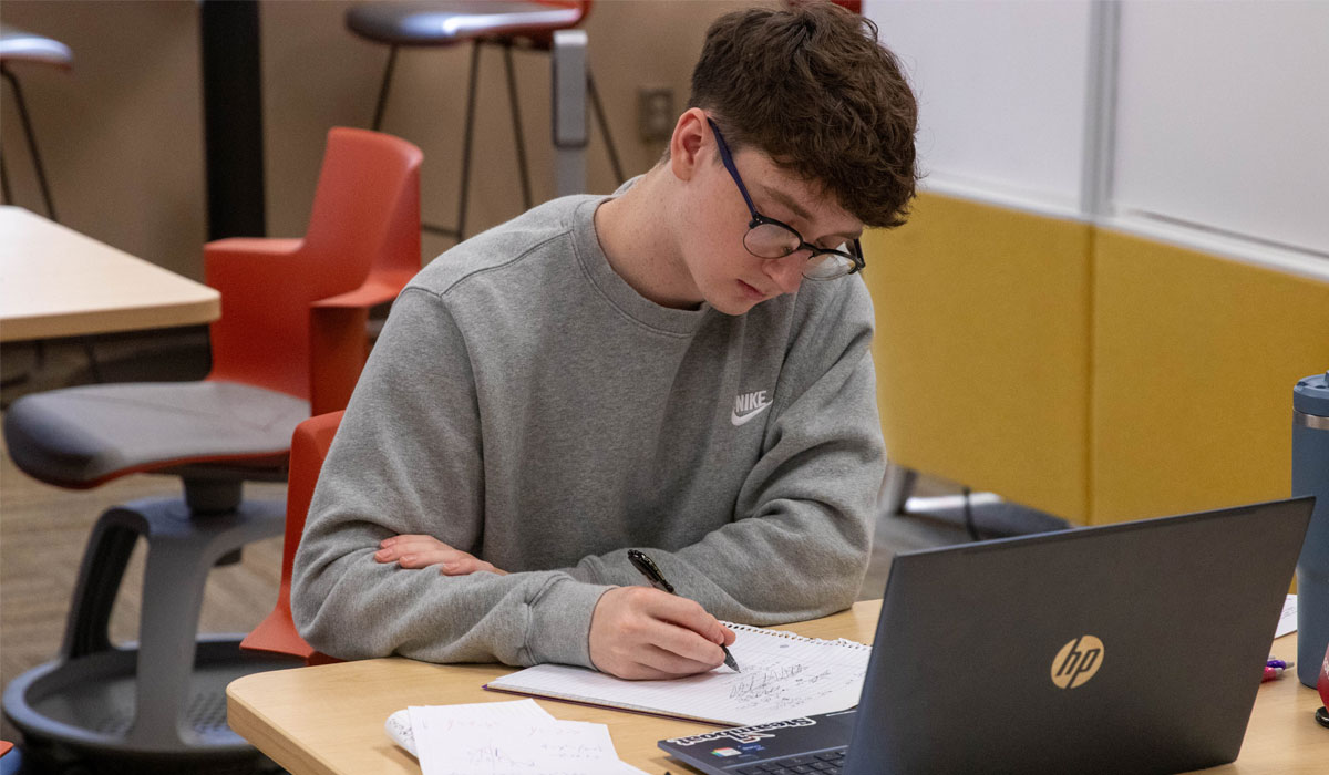 Student works on lap top. 