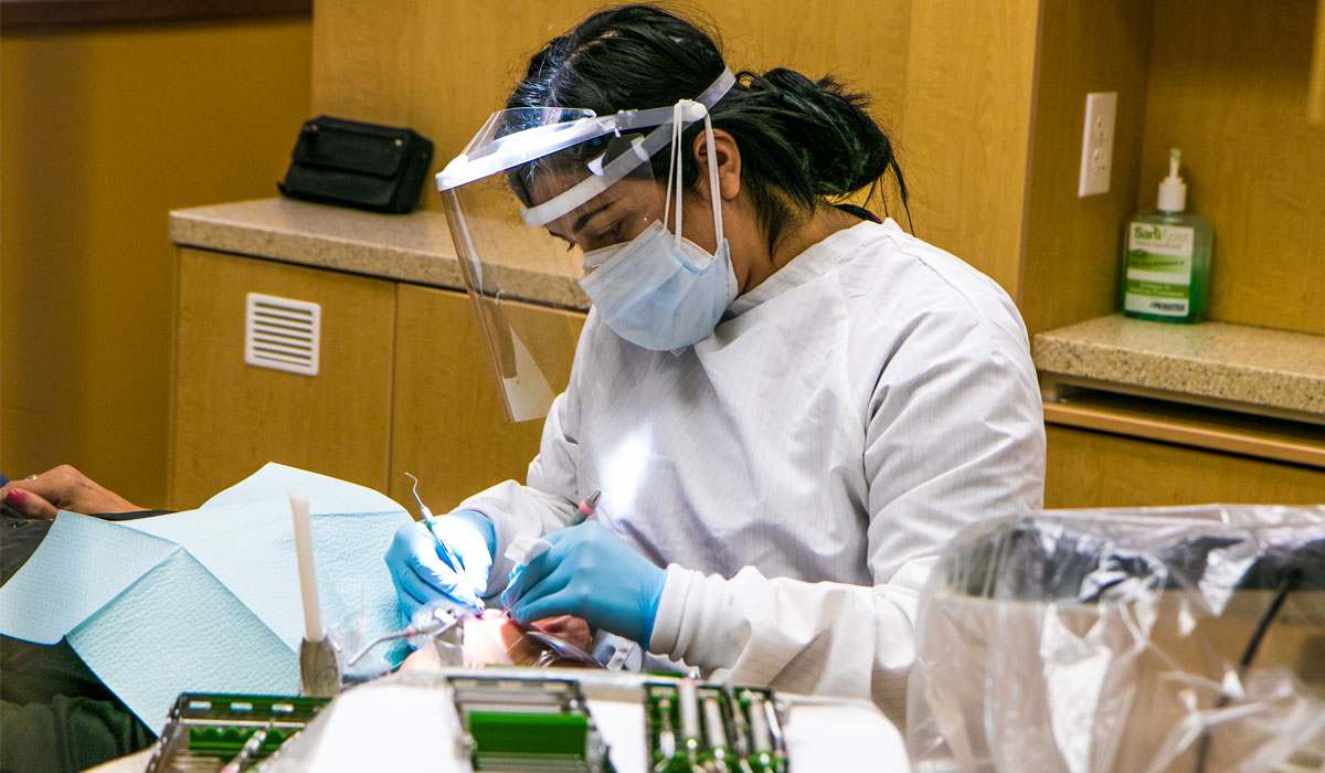 Student works on test patient during a healthcare class. 