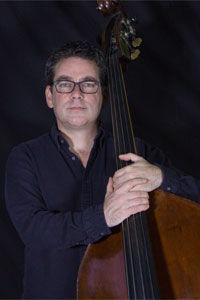 Headshot of Jeff Norwood pictured with his cello.