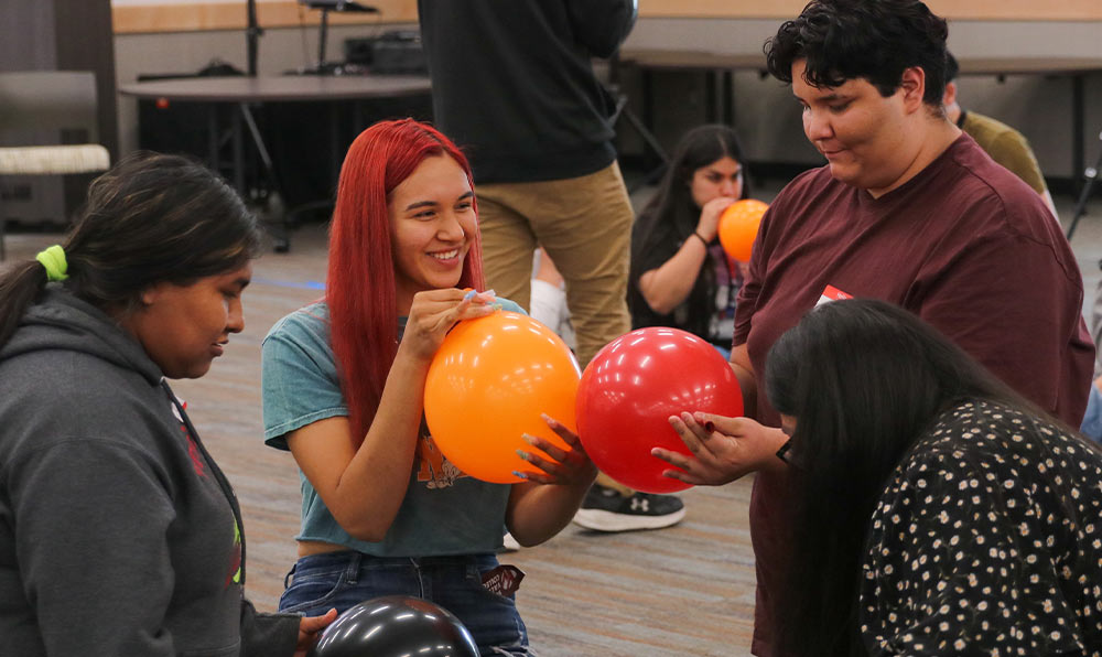 College students blow up balloons