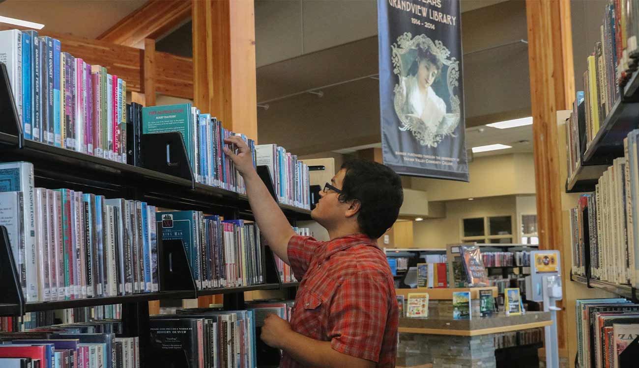 Man browses stacks in library