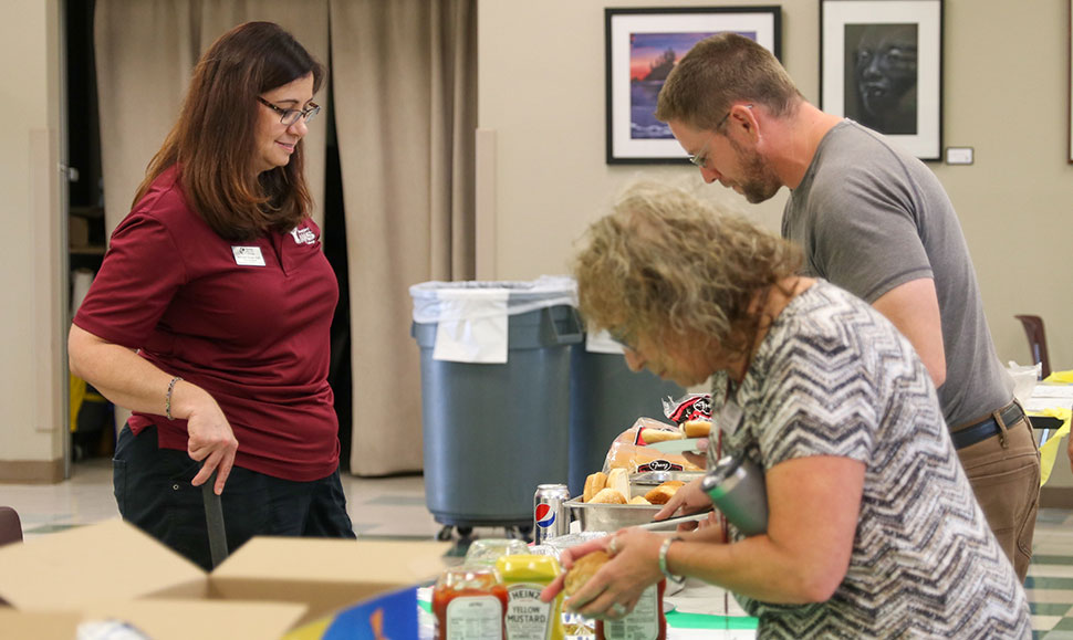 Staff get food at the employee appreciation bbq