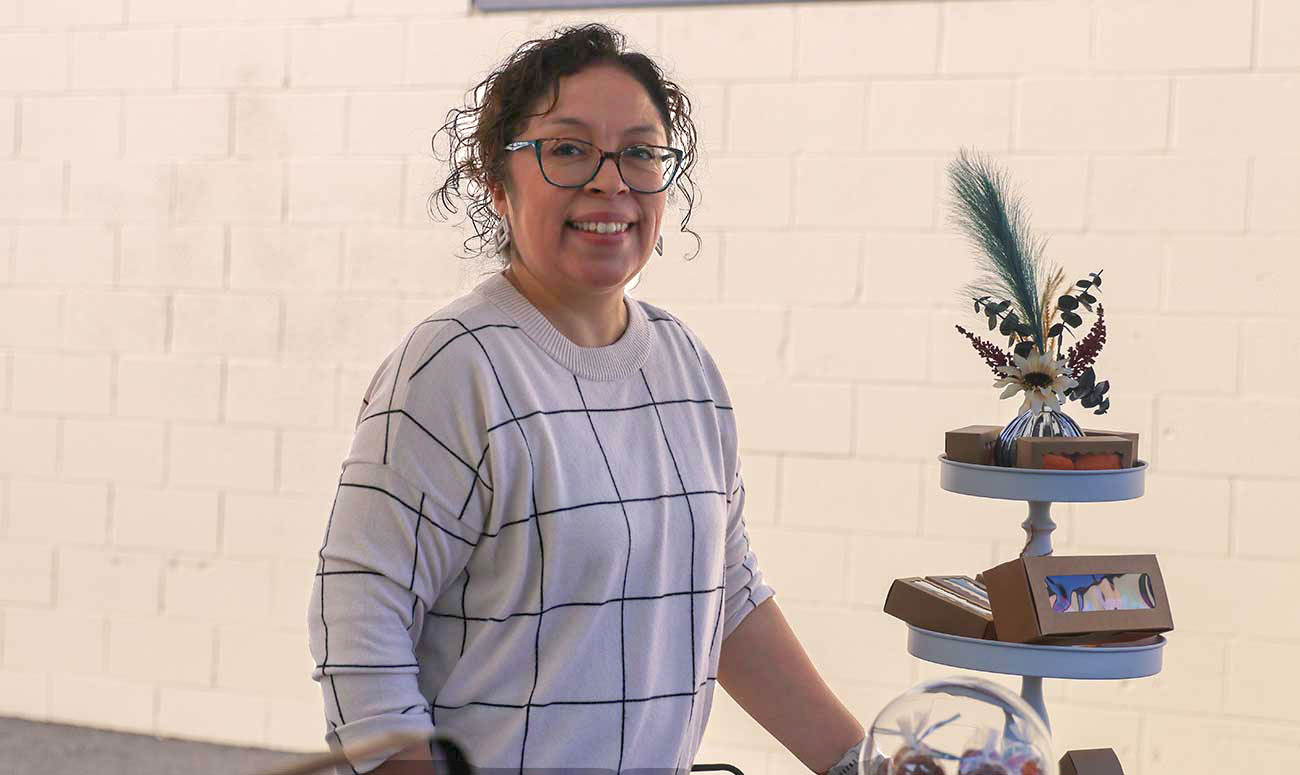 Rachel Villanueva stands at her booth during YVC's French Market event in September.