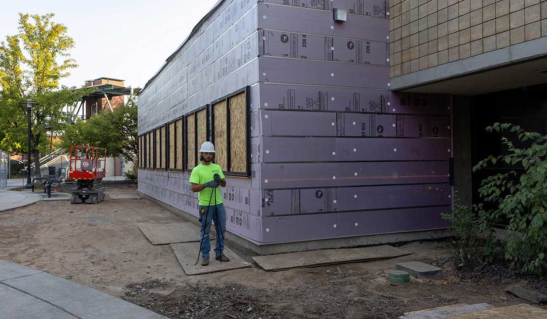 Worker stands outside of YVC's Technology Complex