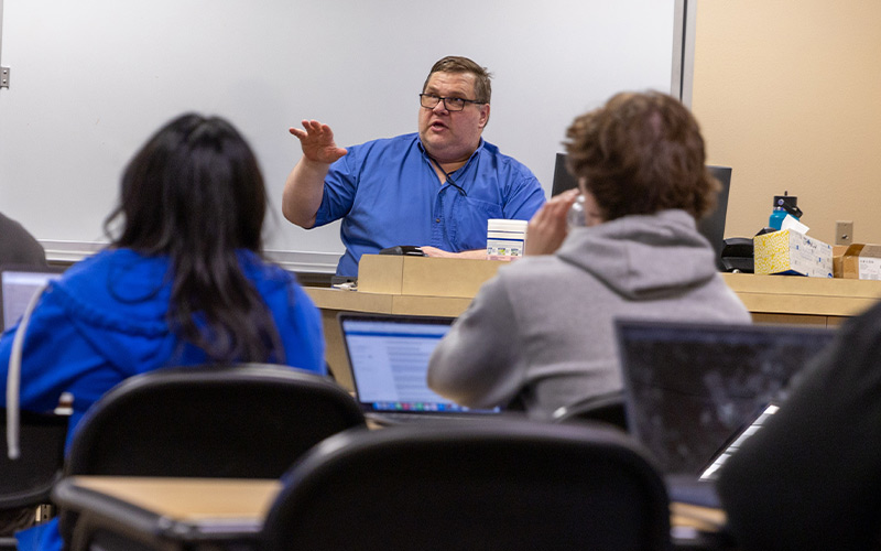 Math Instructor Mike Jenck talks to class