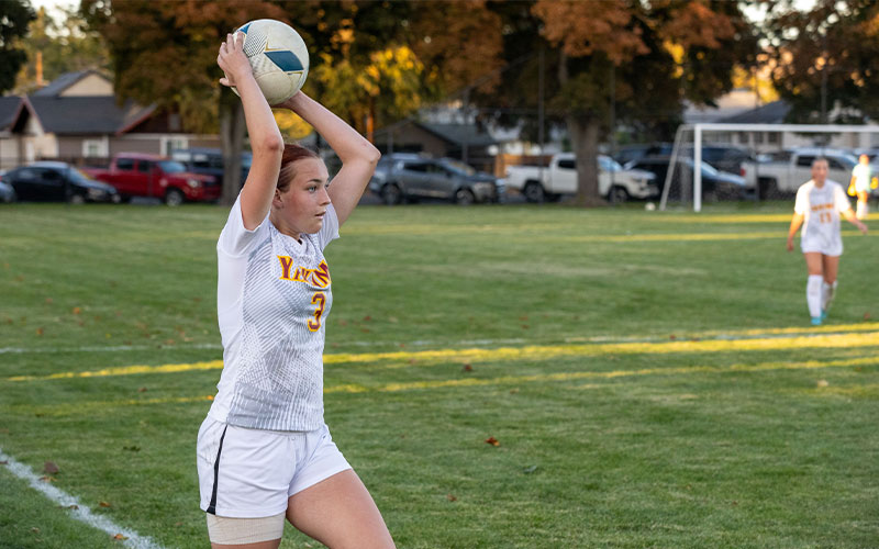 Yakima Valley College soccer player prepares to throw in the ball