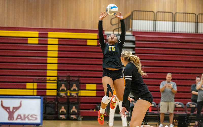 Yakima Valley College volleyball player sets ball