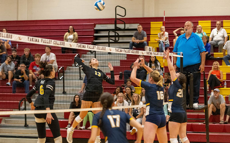 Yakima Valley College volleyball player spikes ball