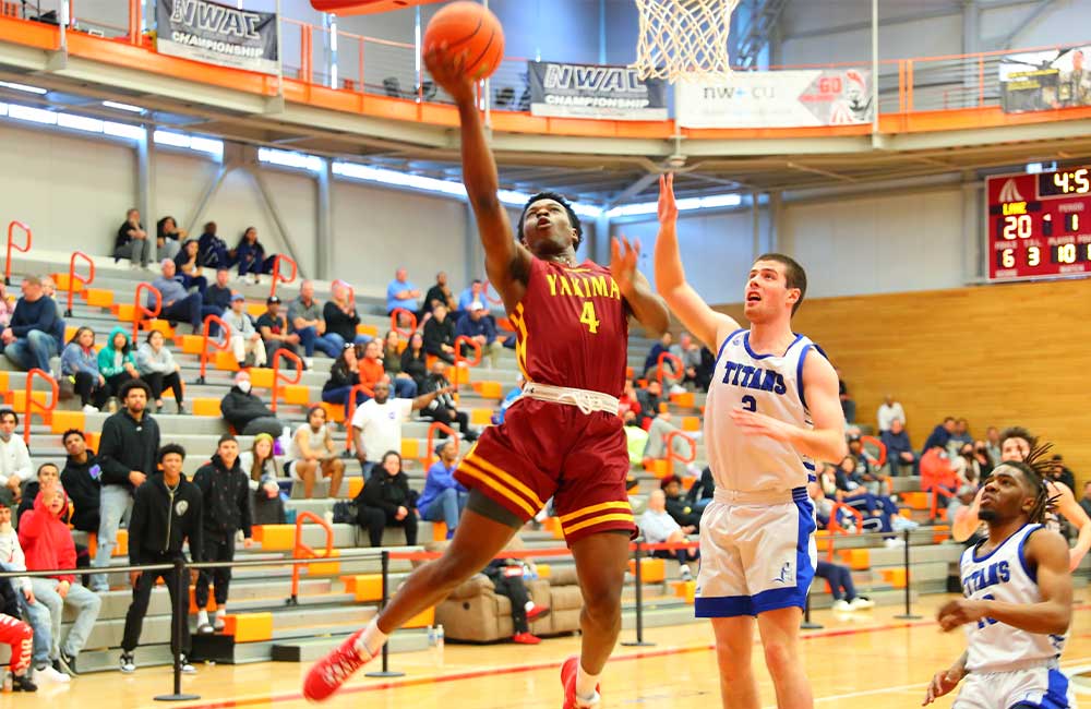 Basketball player attempts layup