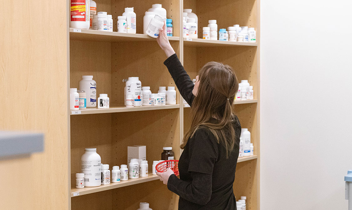 Student reaches for medicine bottle. 