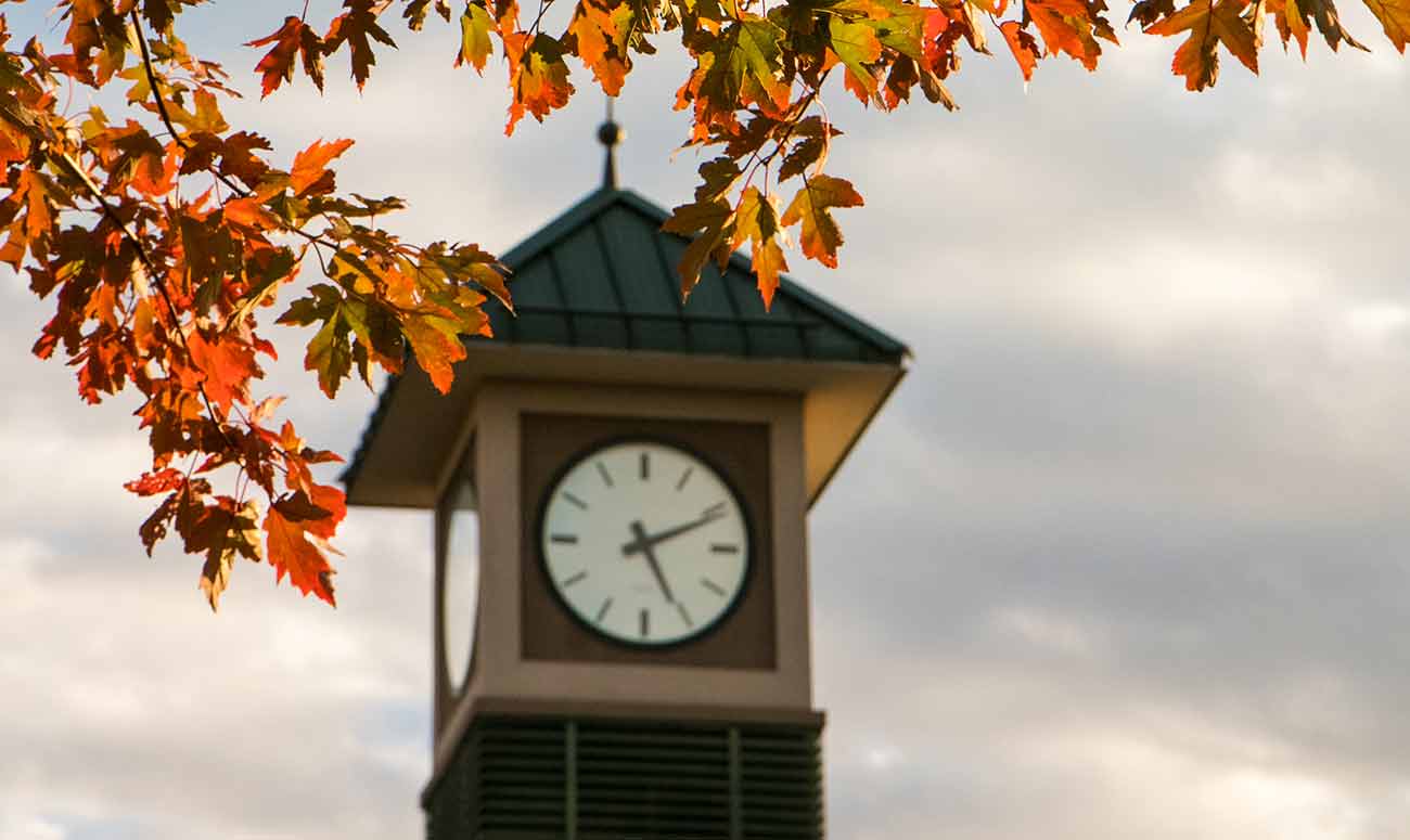 Clock tower with fall leaves