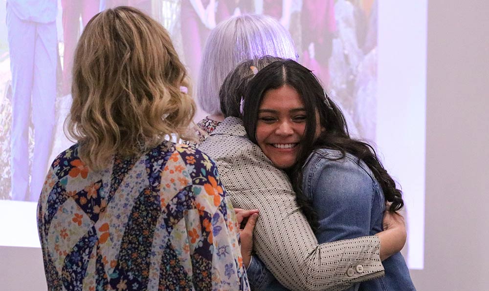 Student hugs instructor