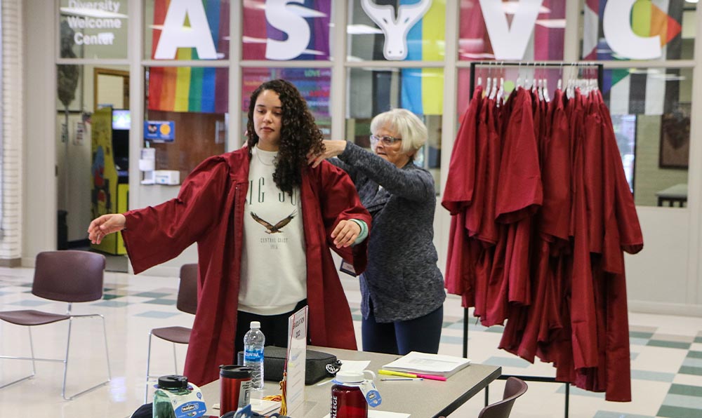 Student tries on graduation gown