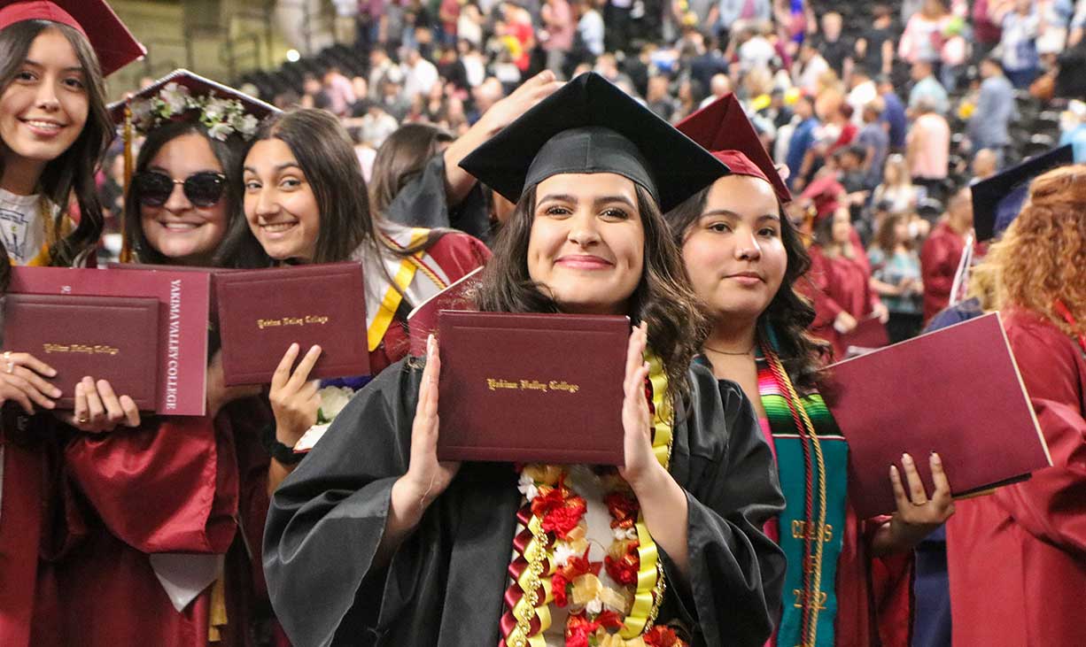 Students smiling at commencement ceremony