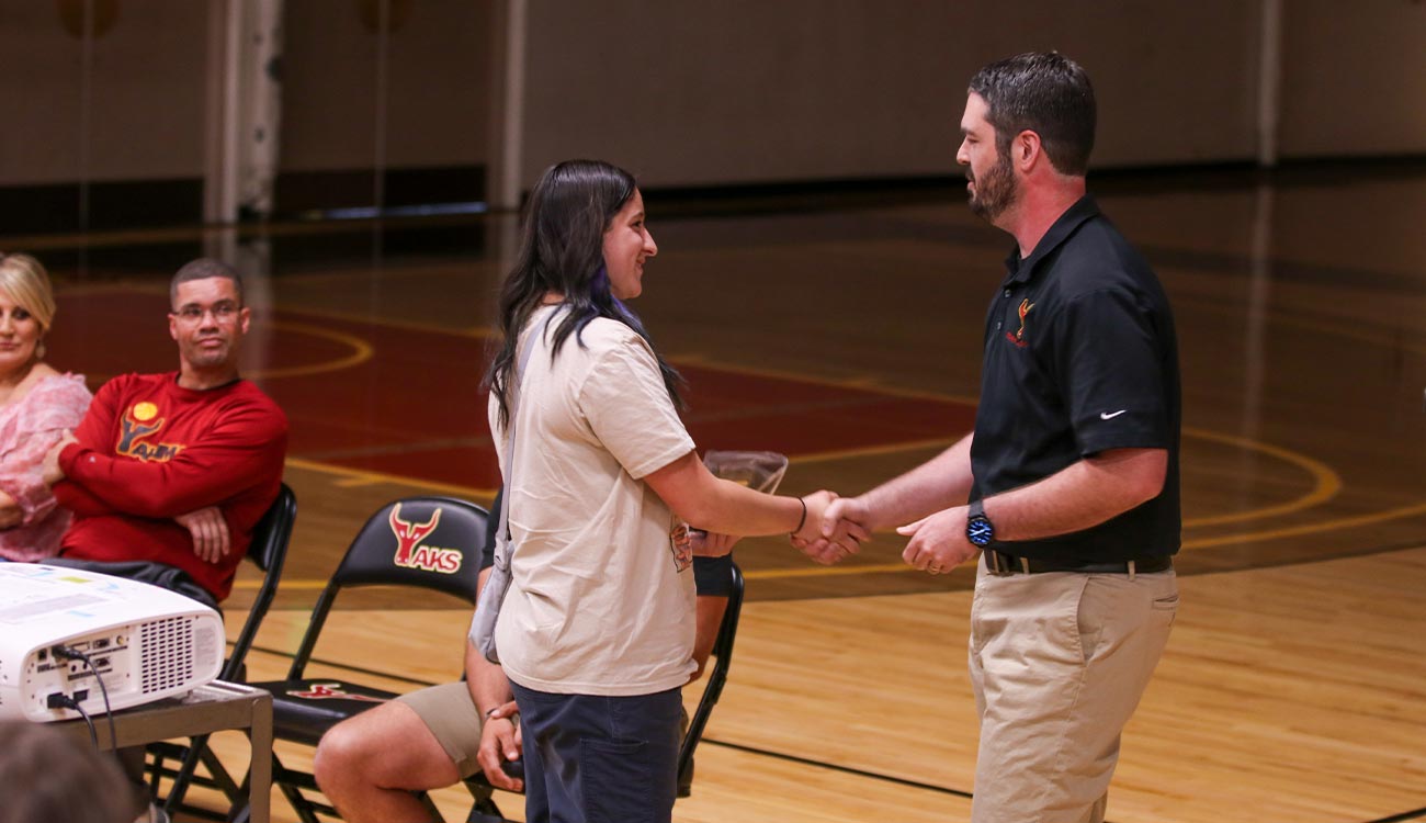 Coach shakes players hand