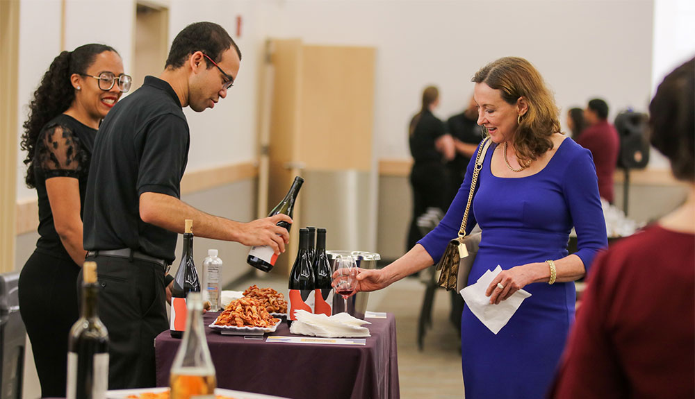 Wine program students pour wine