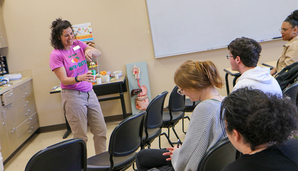 Instructor talks to students in nutrition classroom