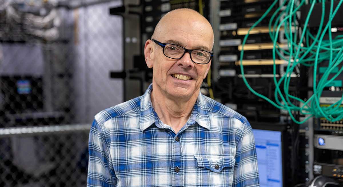 Stefan Apperson pictured in front of IT equipment.