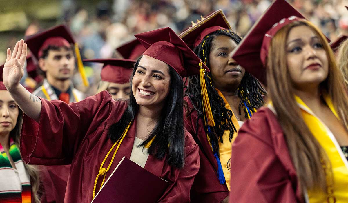 Students smiling at commencement ceremony