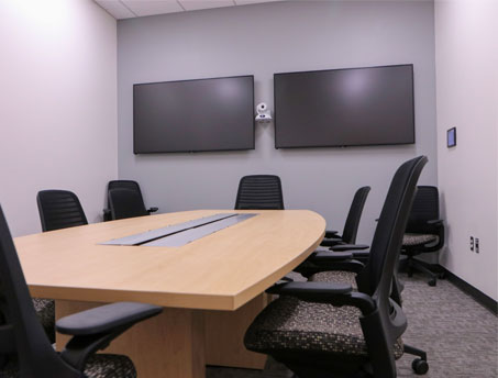 Picture of an empty small conference room. 