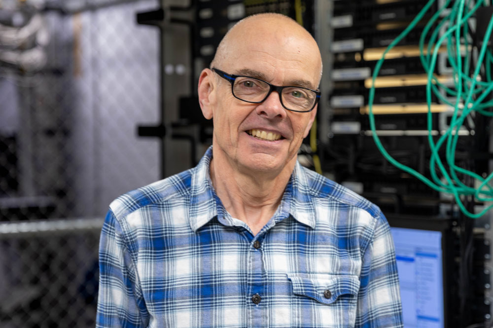 Stefan Apperson is pictured in front of computer servers. 