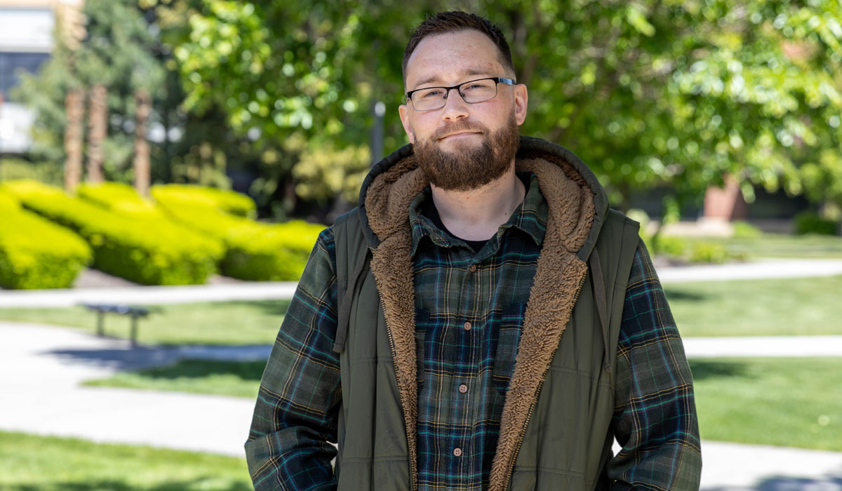 Michael Hammet poses for student story picture on the YVC Campus