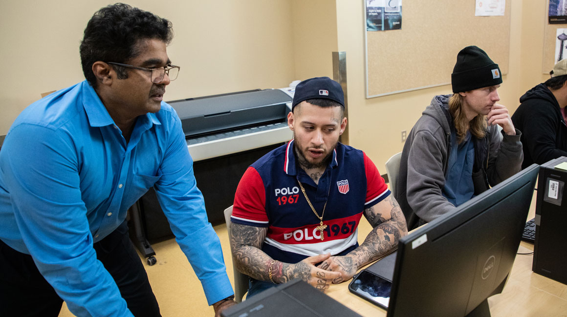 YVC instructor works with student in a YVC computer lab. 