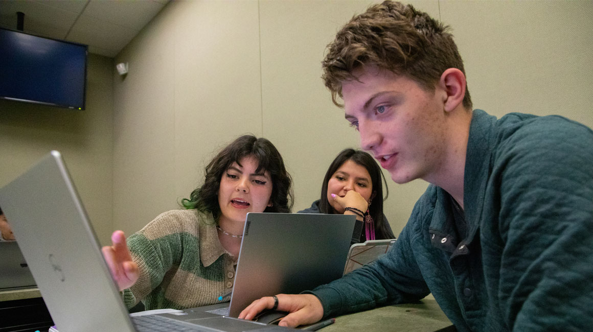 Student works on laptop during class. 